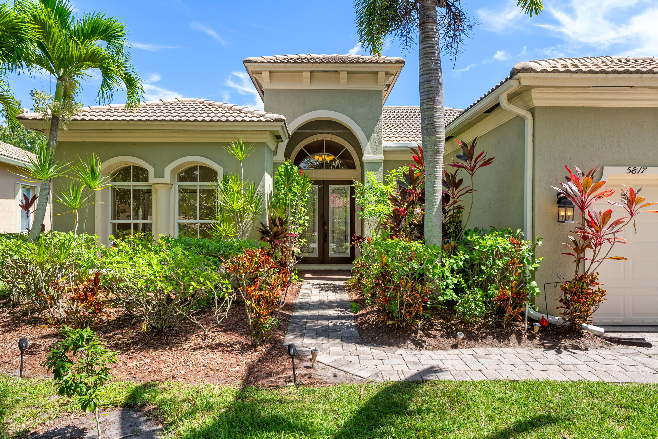 a front view of a house with garden