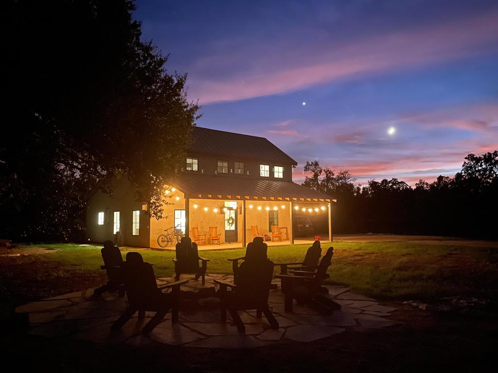 a view of a patio with dining table and chairs with fire pit