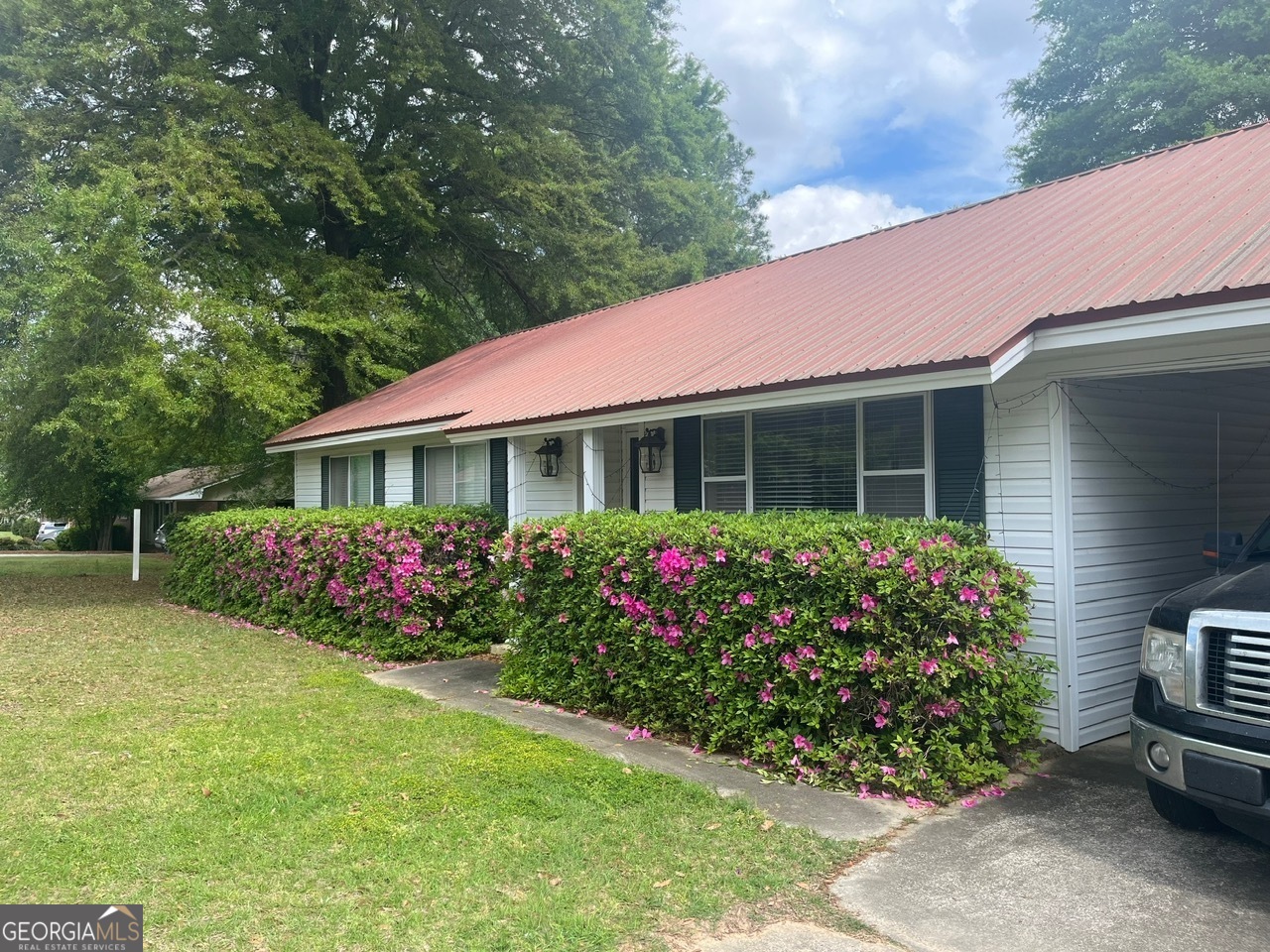 a front view of a house with a garden