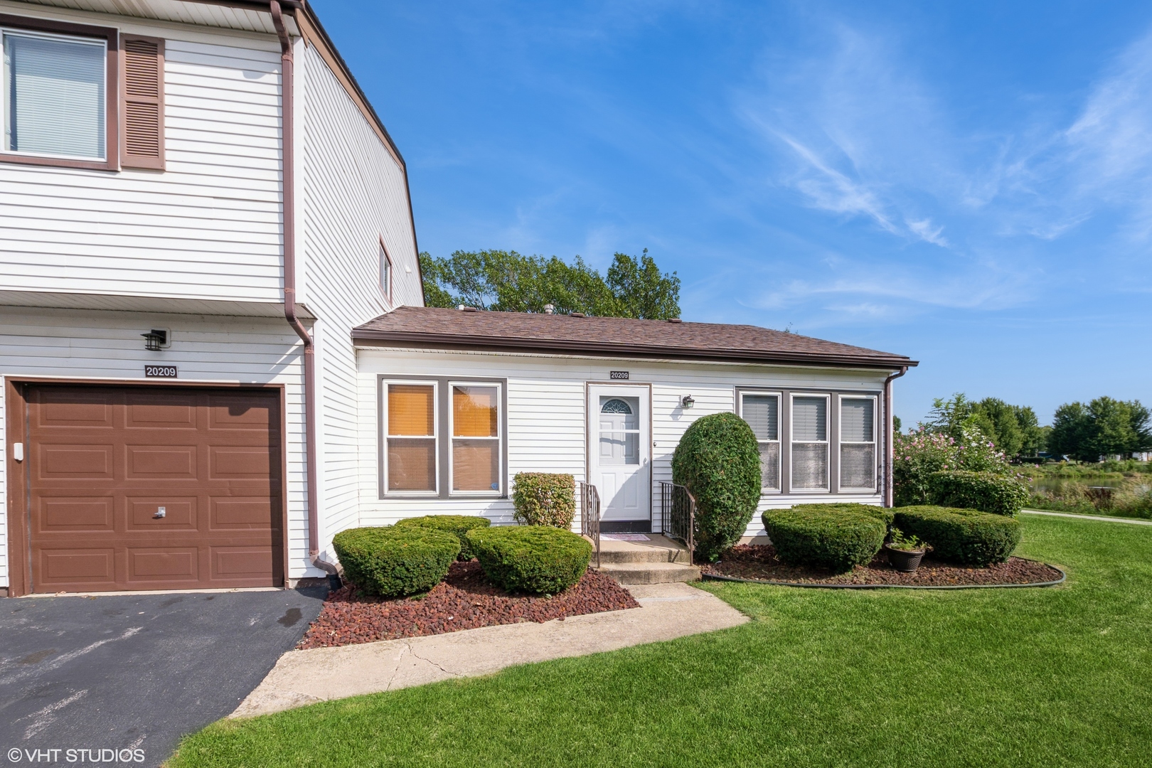 a view of a yard in front of a house with plants