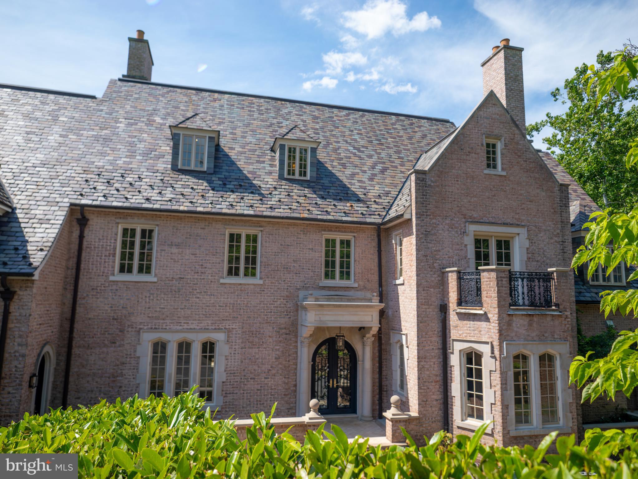 a front view of a house with lots of green space