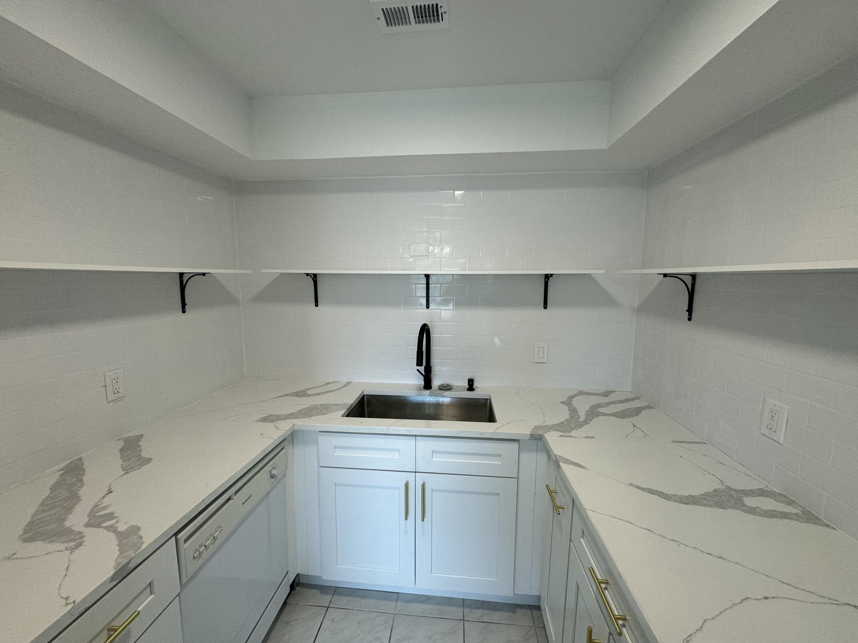 a kitchen with a sink and cabinets