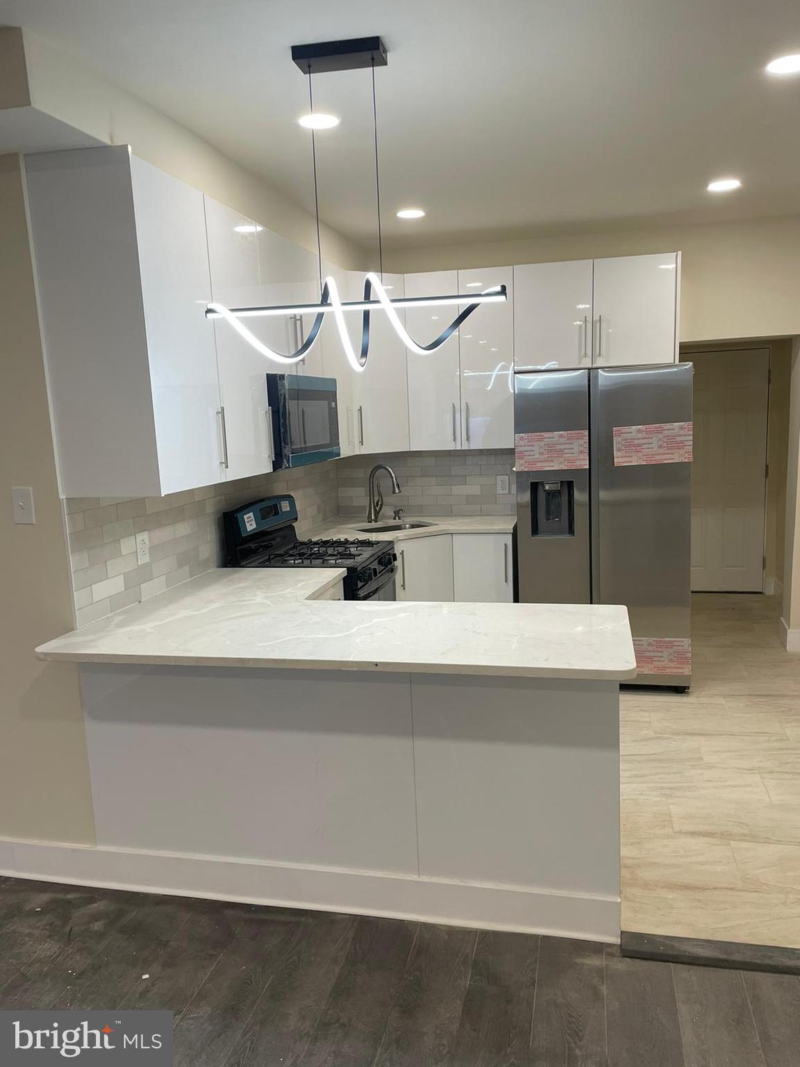 a kitchen with stainless steel appliances granite countertop a sink and a stove