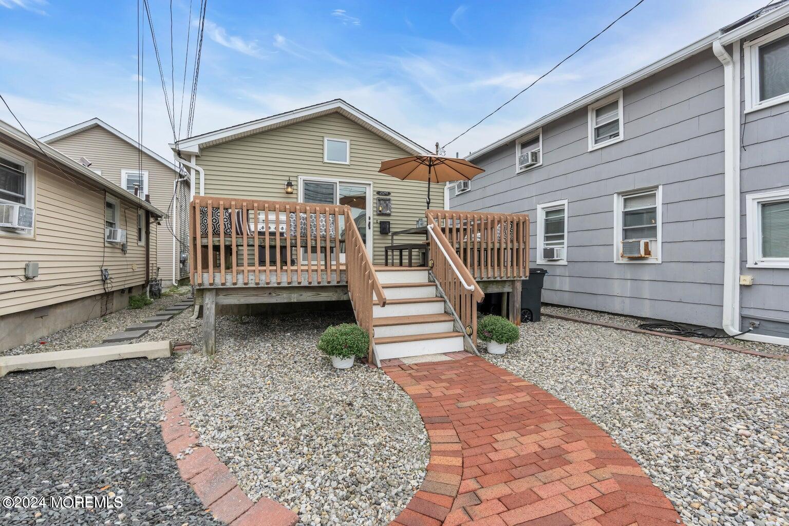 a view of a house with a small deck