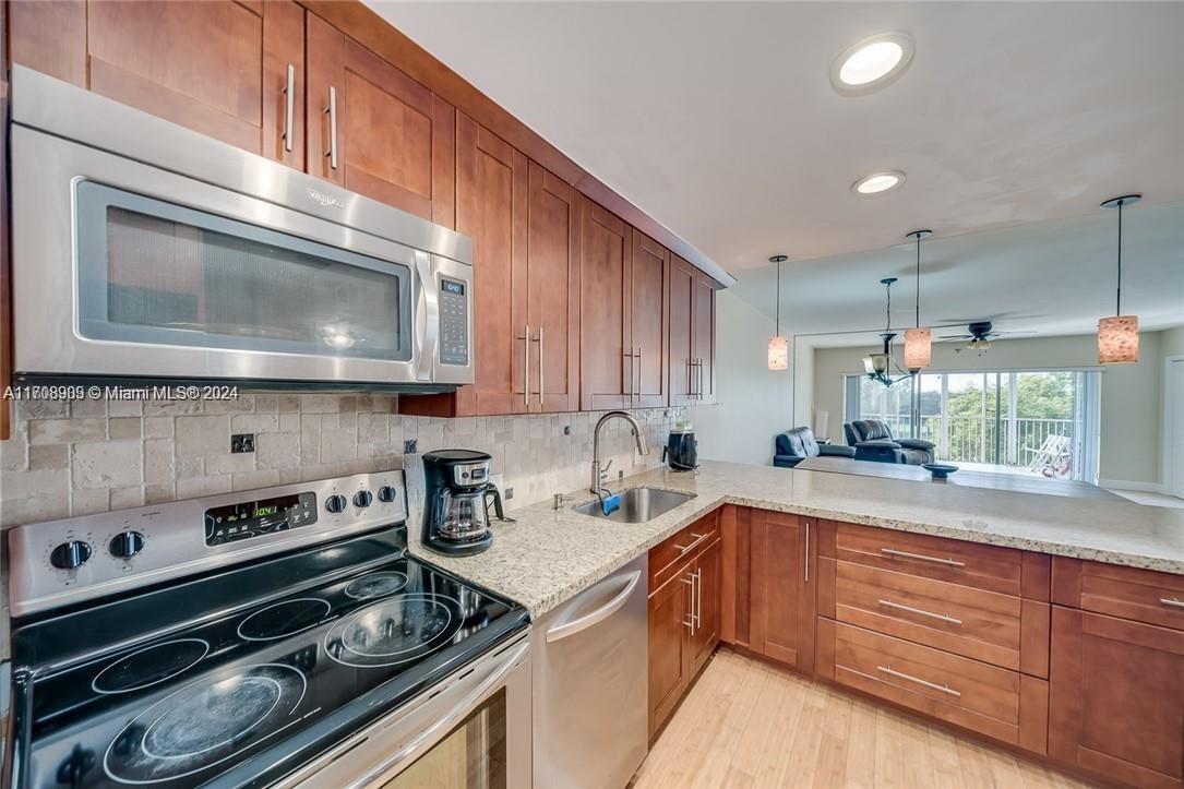 a kitchen with a stove microwave and sink