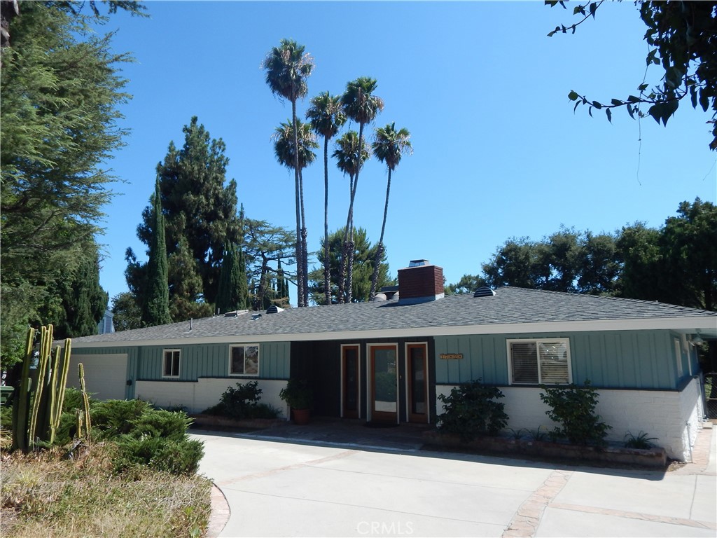 a front view of house with a garden