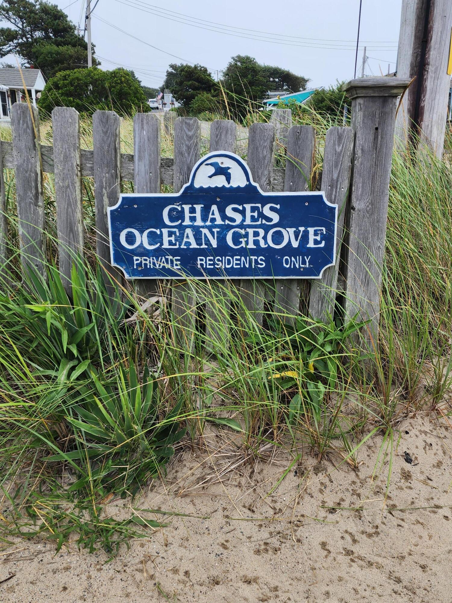 a view of a wooden sign board with yard