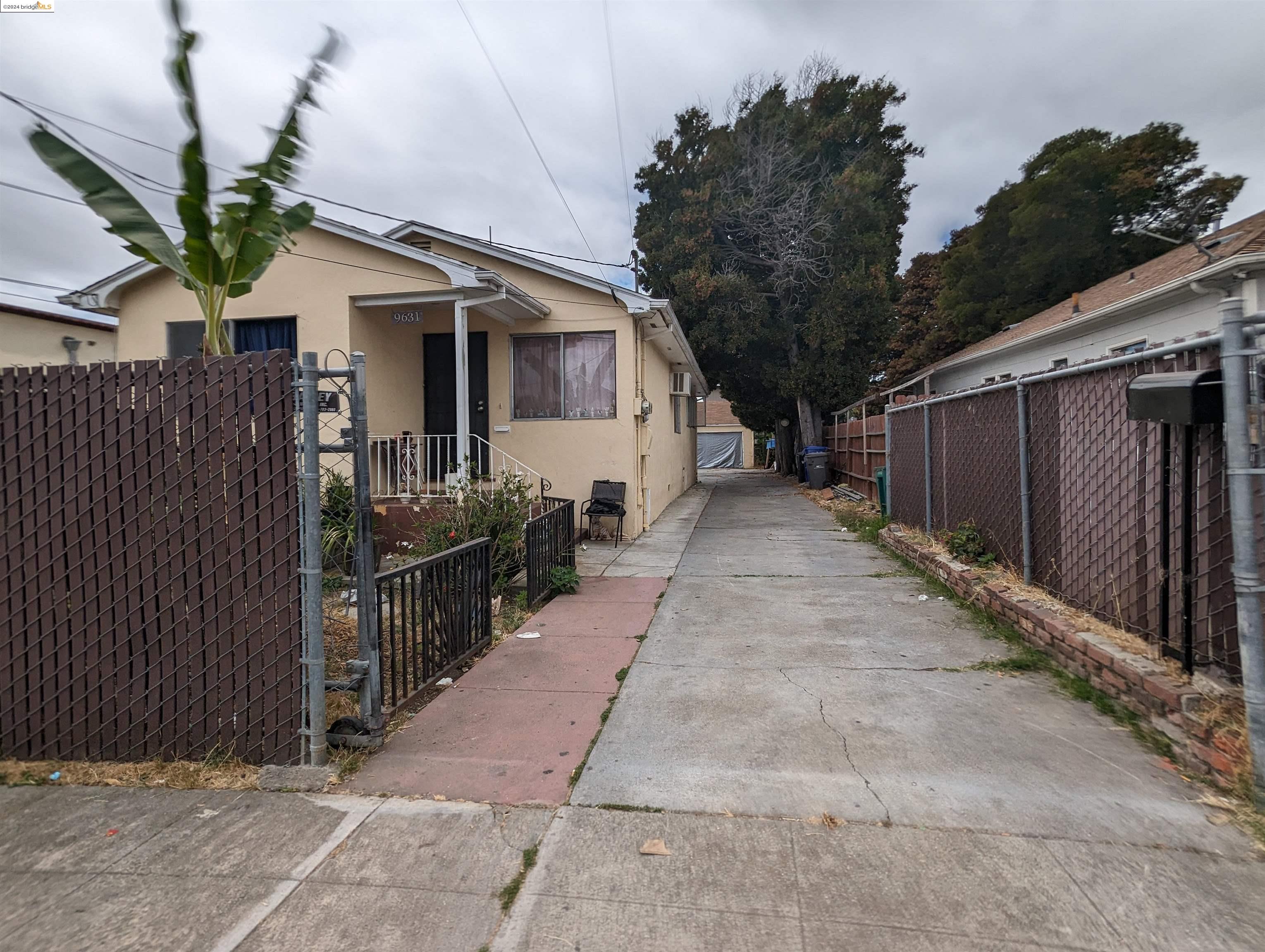 a view of a house with wooden fence