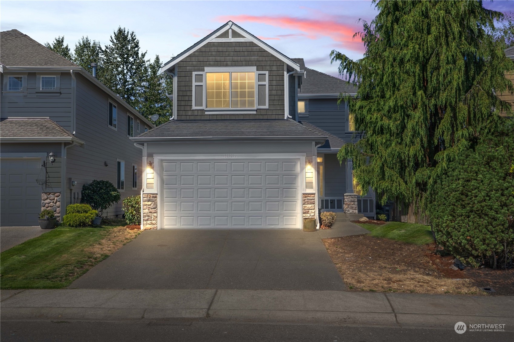 a front view of a house with a yard and garage