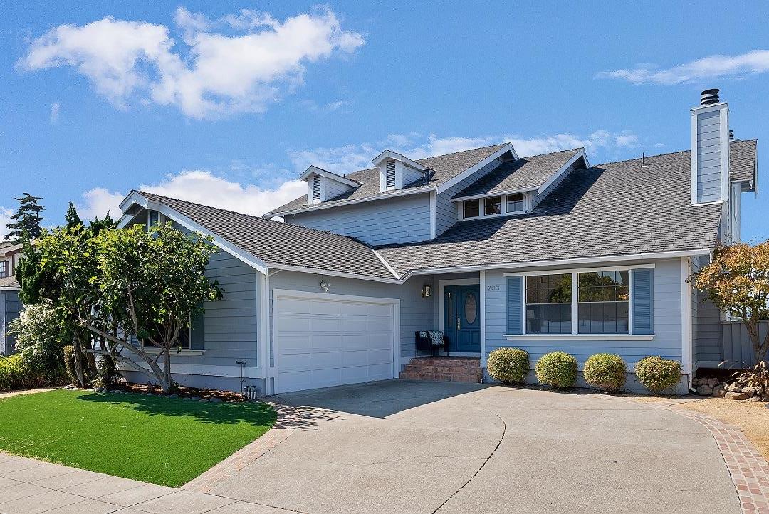 a front view of a house with a garden and plants