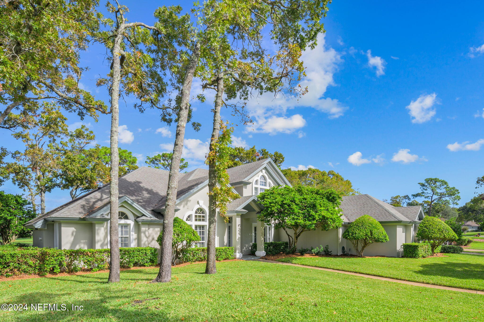 a front view of a house with garden