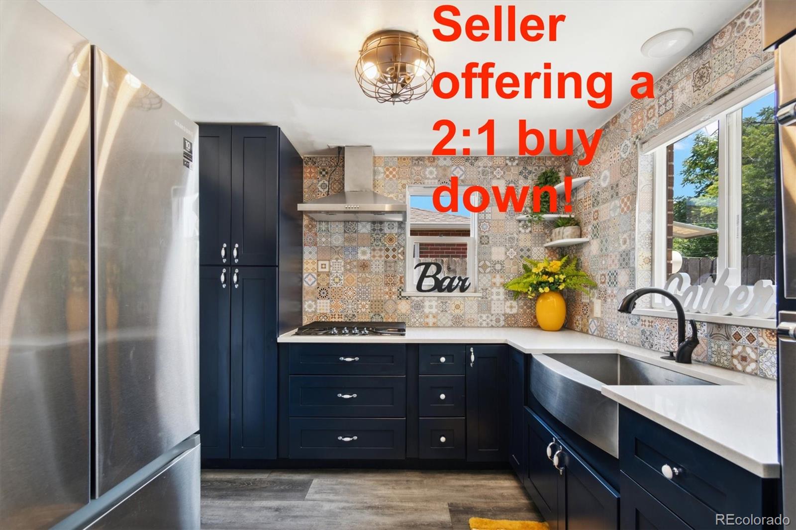 a kitchen with kitchen island a sink and a refrigerator