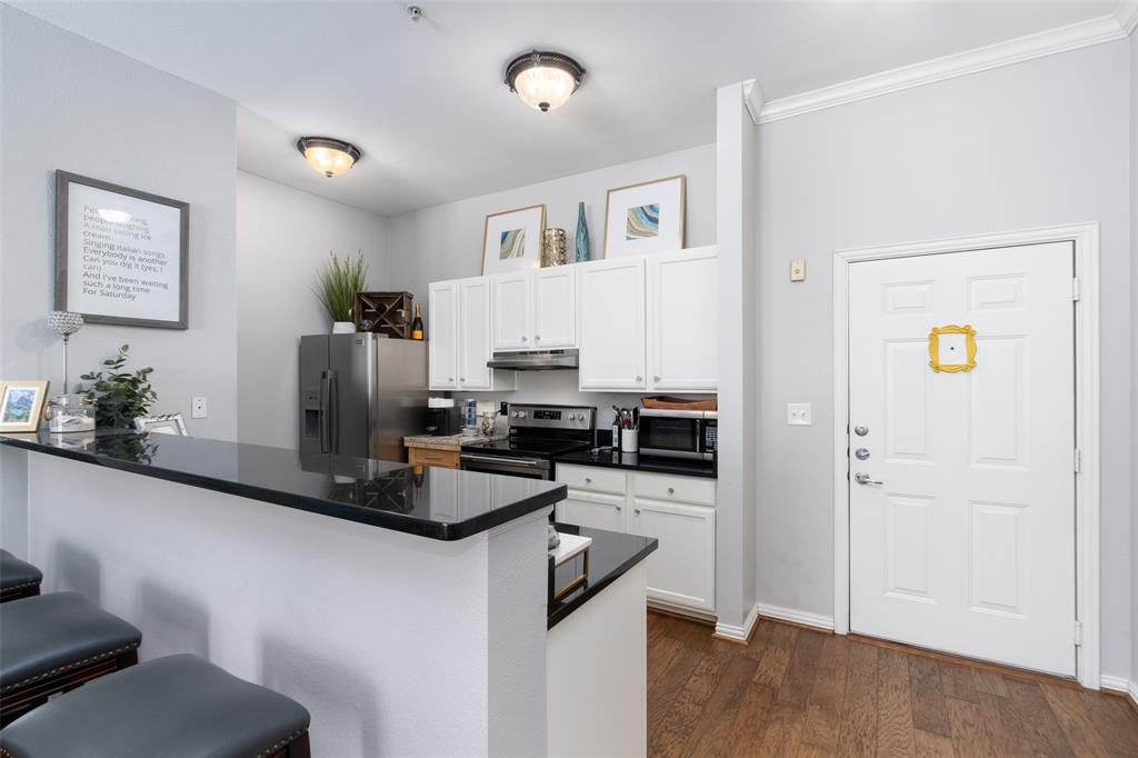 a kitchen with stainless steel appliances granite countertop a refrigerator and a stove top oven