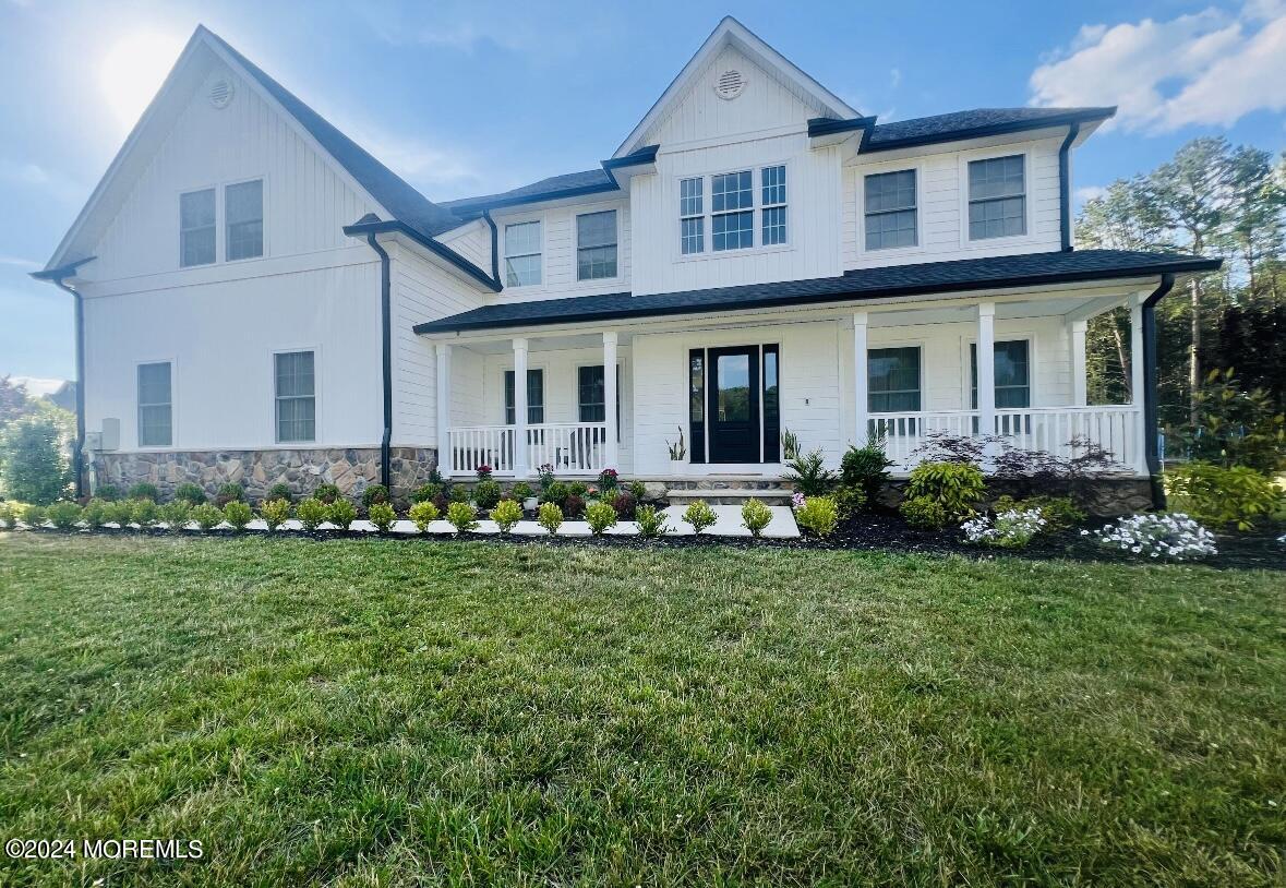 a front view of a house with a garden and yard