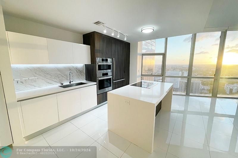 a kitchen that has a sink and a stove