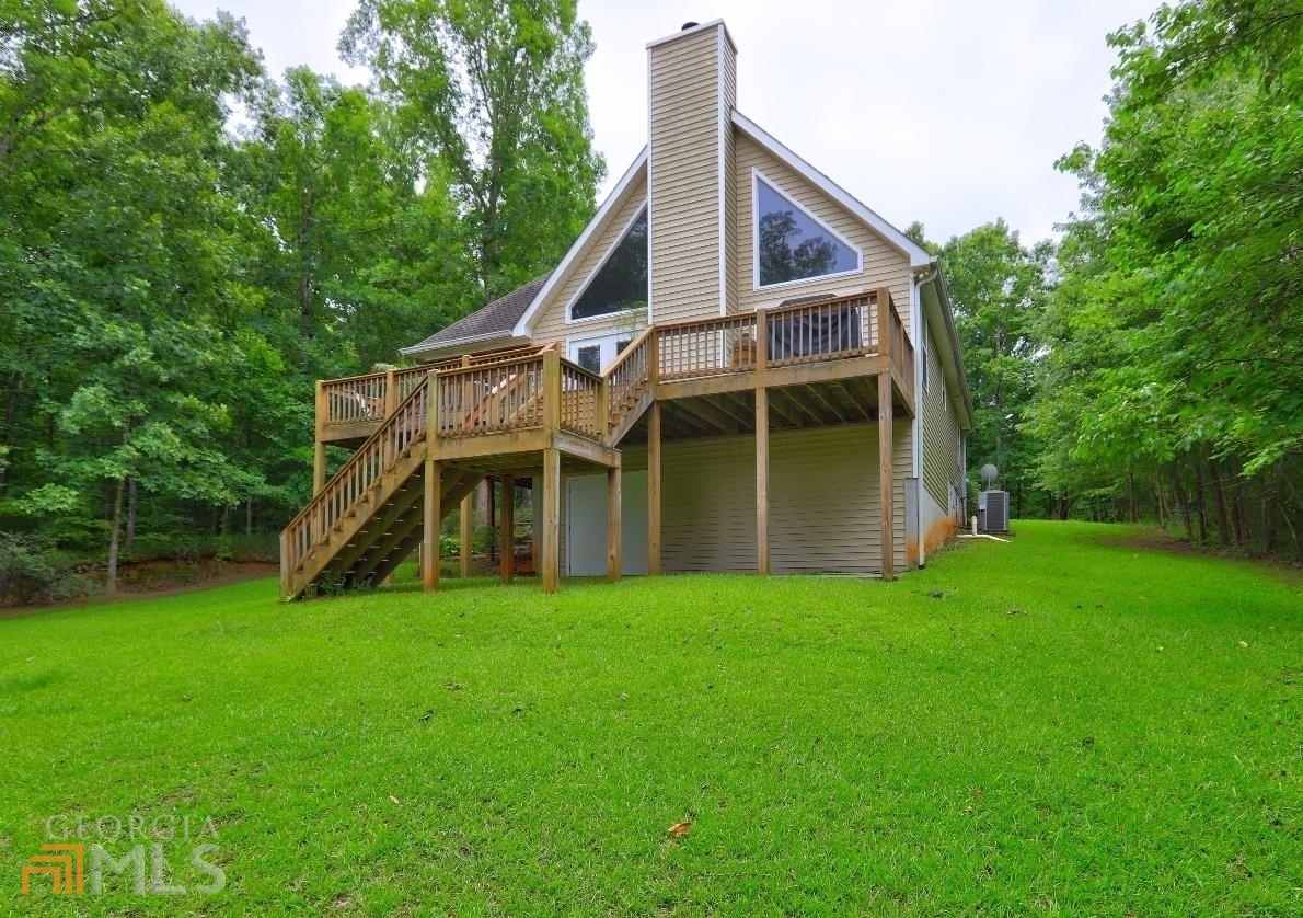 a view of a house with a yard and sitting area