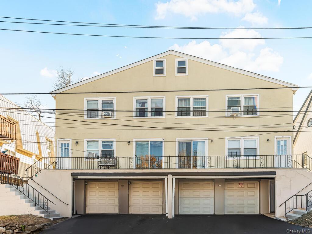 Townhome / multi-family property featuring a garage