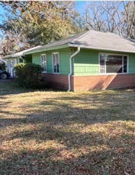 a view of house with yard and swimming pool