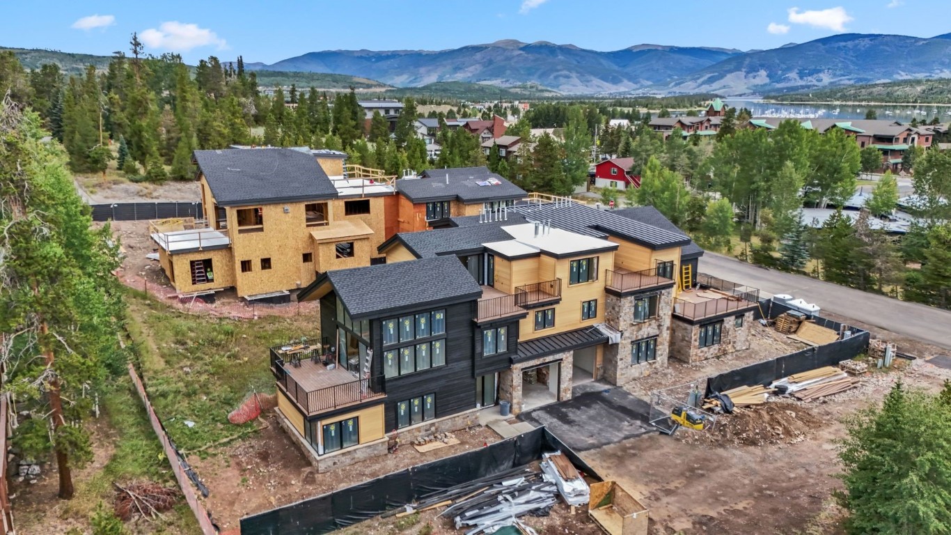 an aerial view of multiple houses with a yard