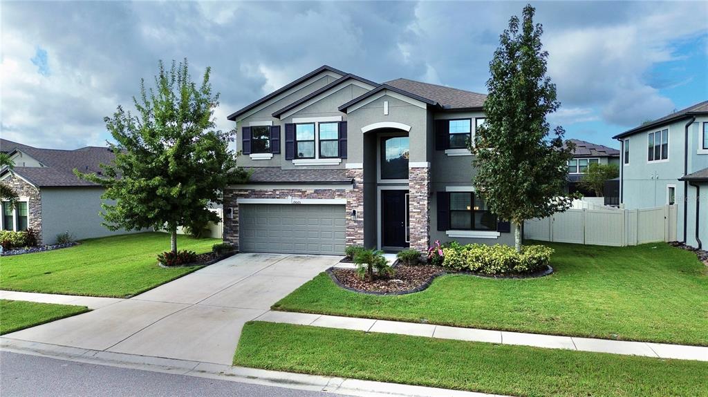 a front view of a house with a yard