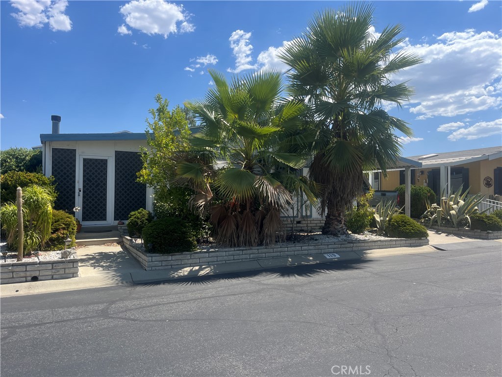 a view of a house with palm trees