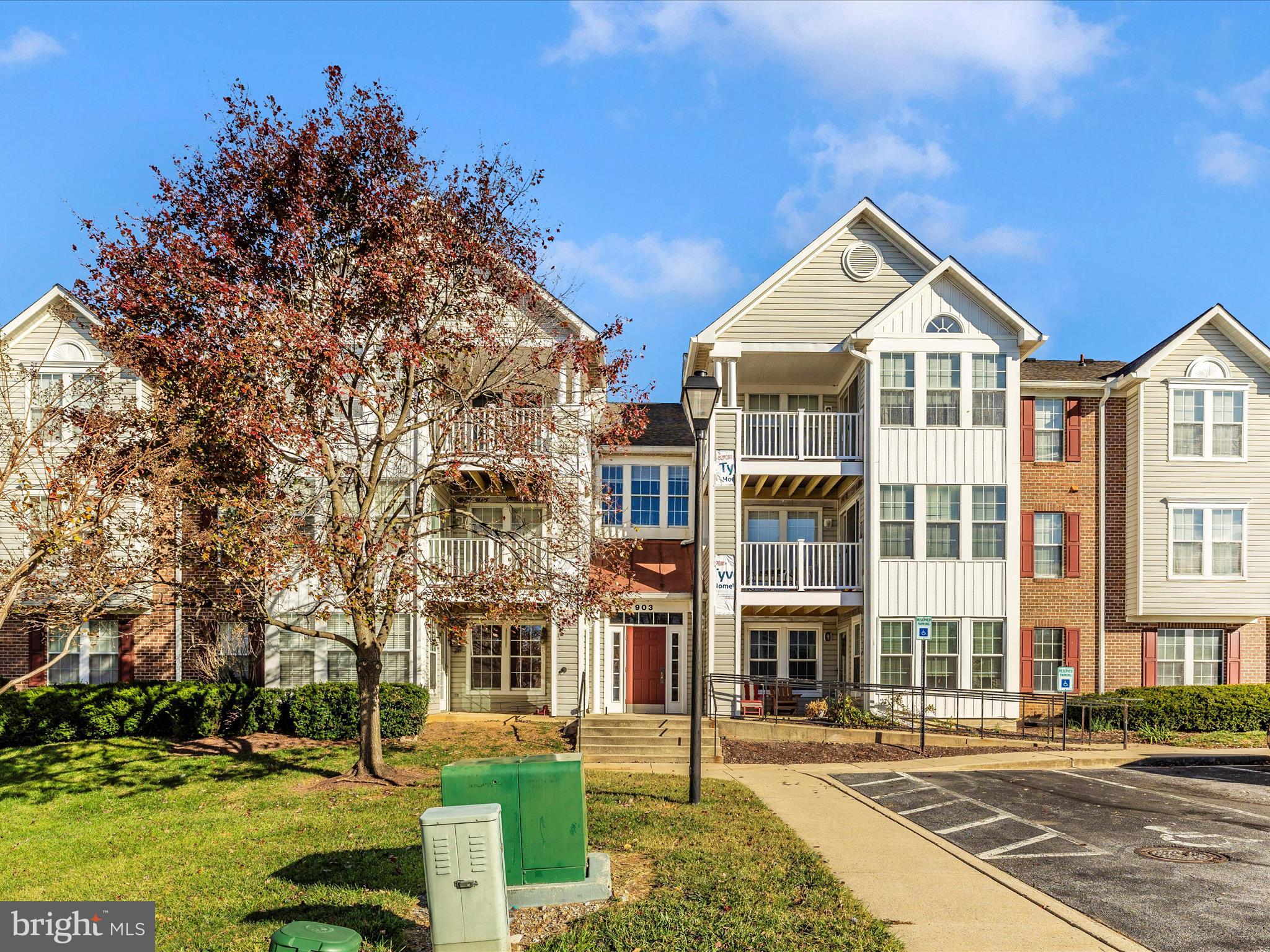 a front view of a residential apartment building with a yard