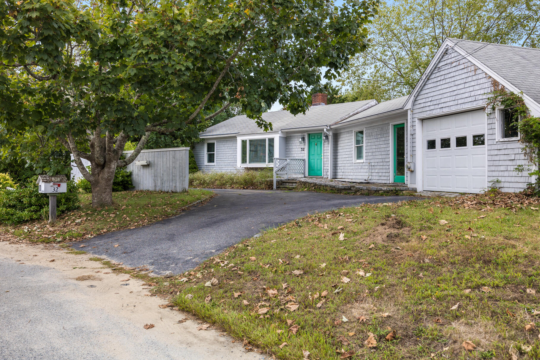 a front view of a house with a garden and yard