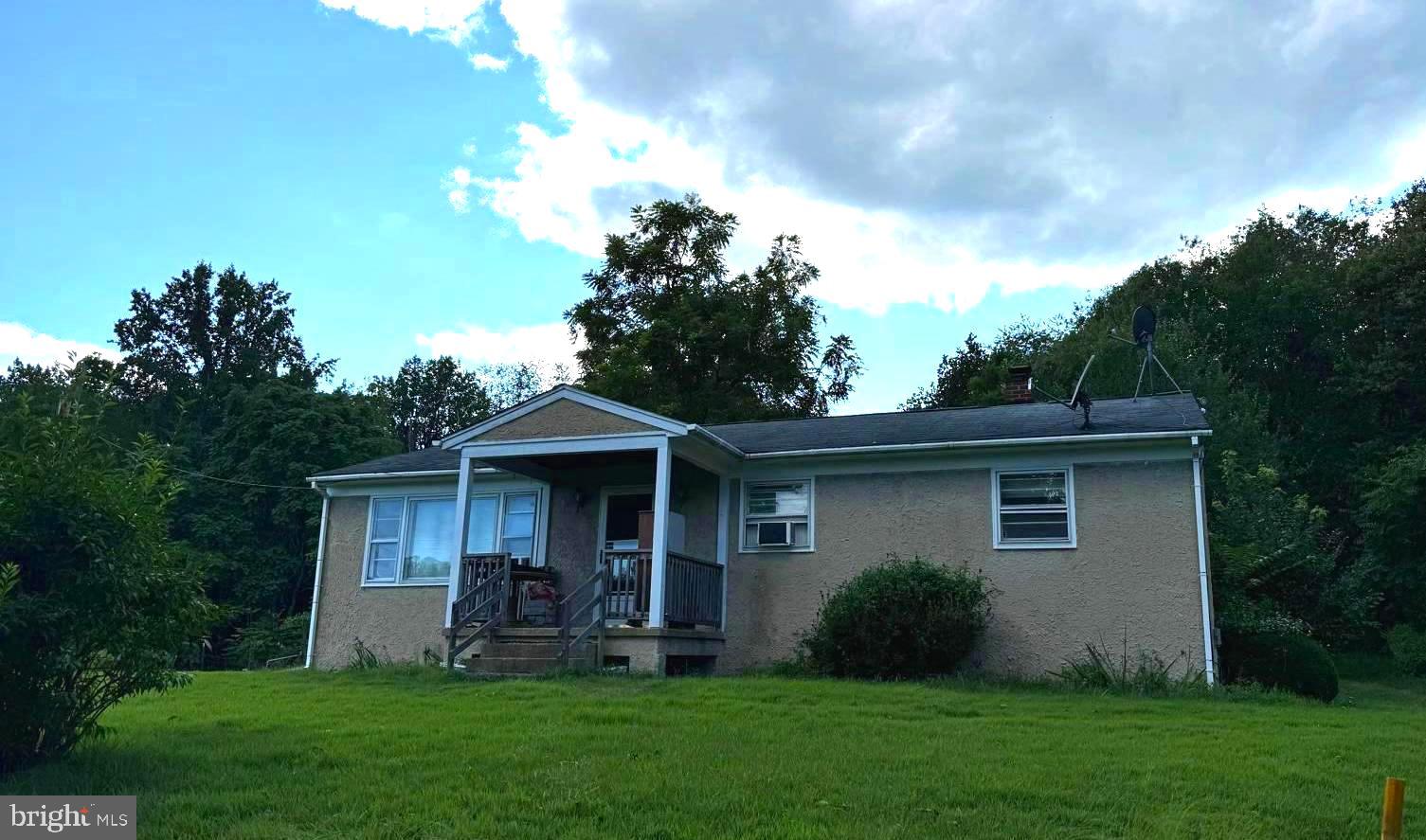 a front view of a house with a yard and porch