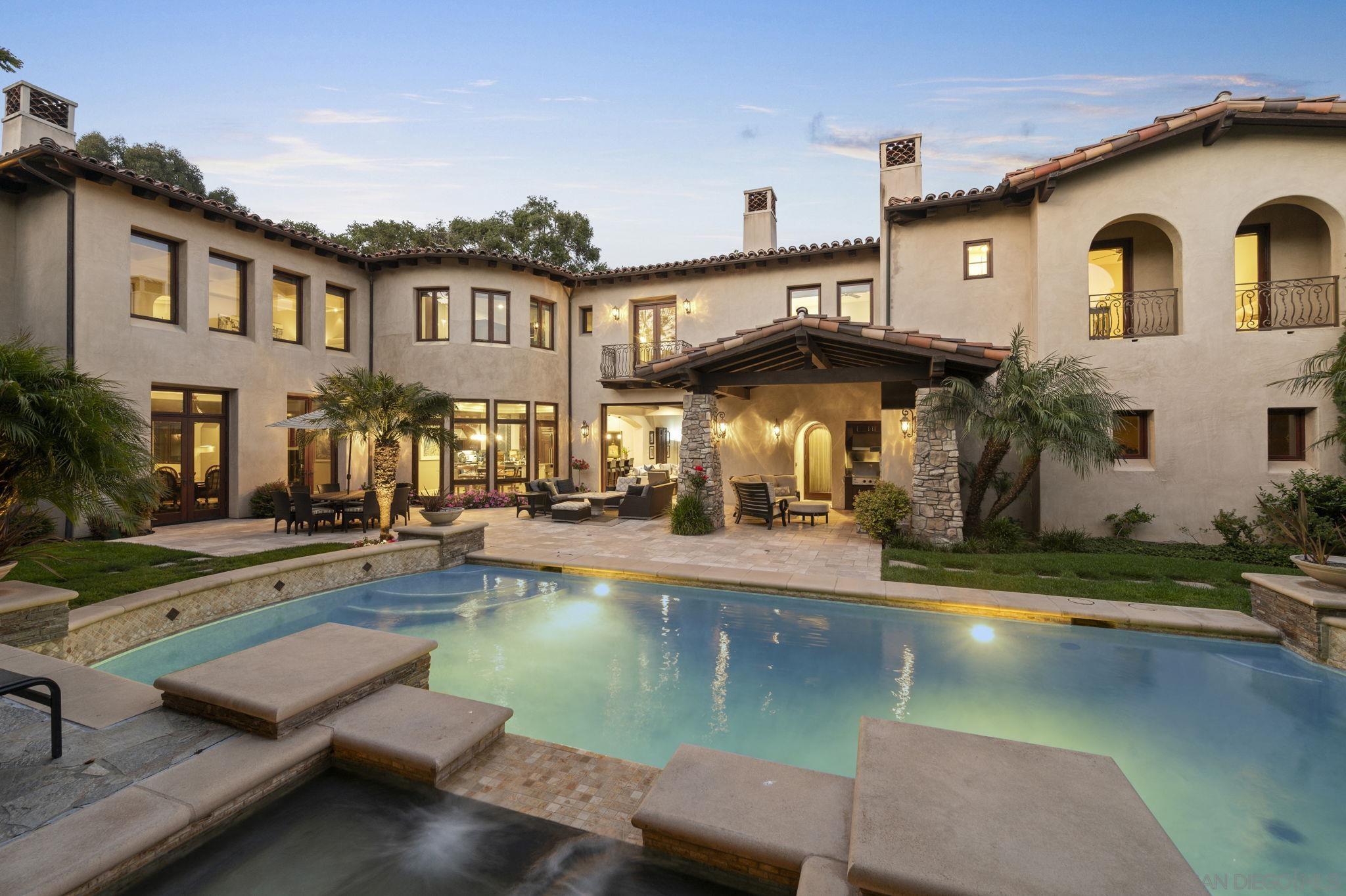 a view of a house with pool and chairs