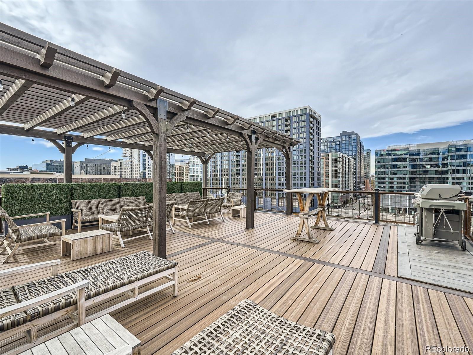 a view of a rooftop with chairs and tables