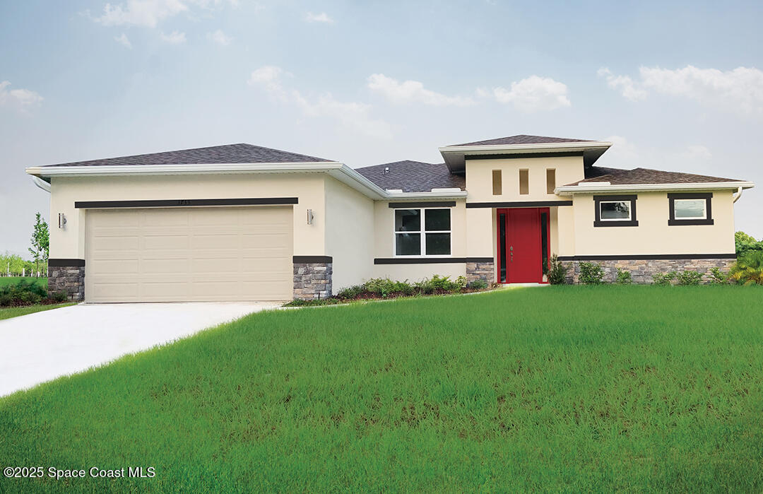 a front view of house with yard and garage