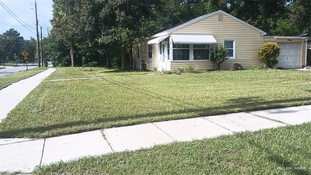 a front view of house with yard and green space