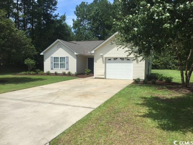 Single story home featuring a garage and a front l