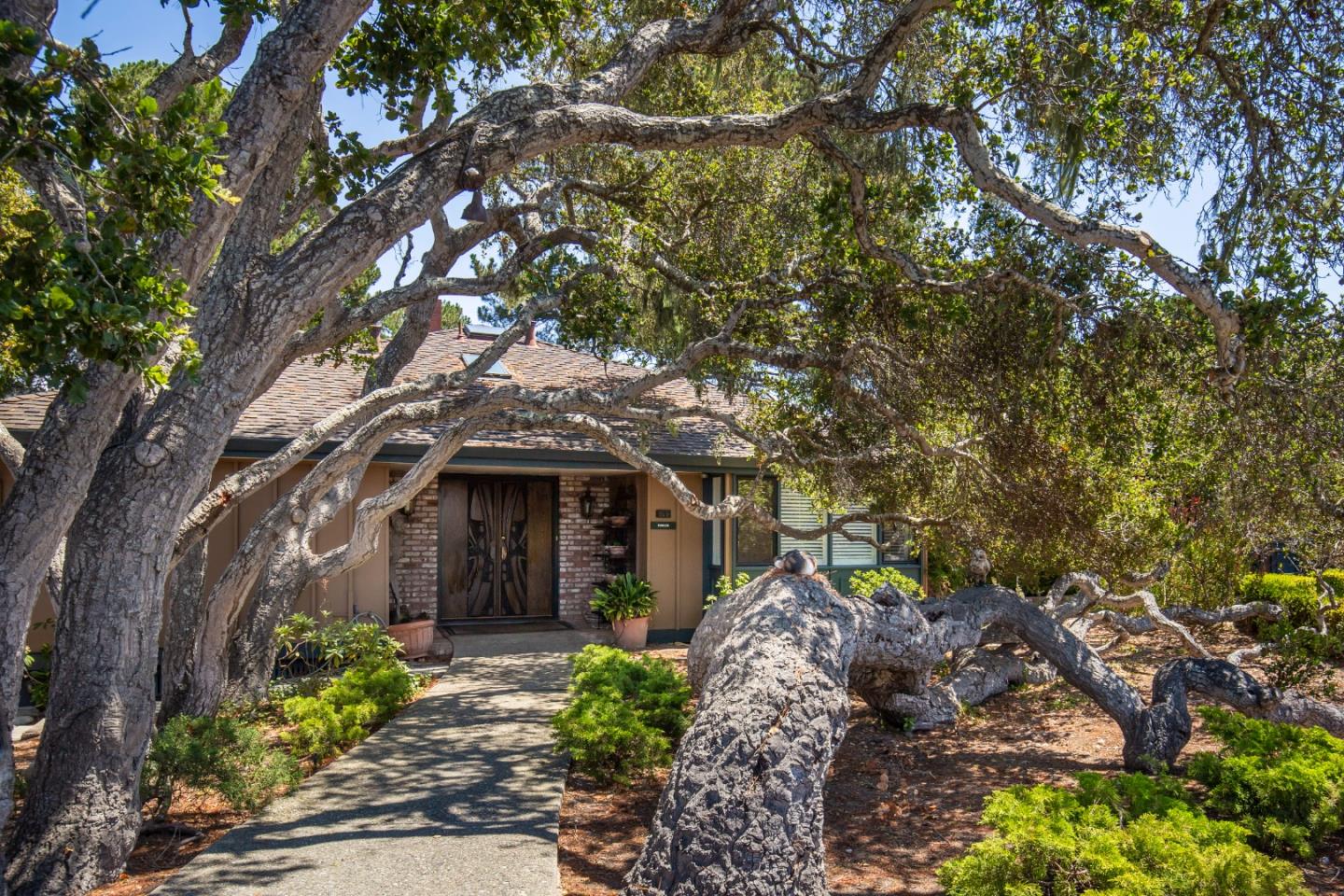 a front view of a house with garden