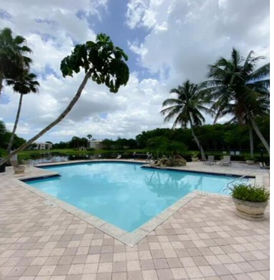 a view of a swimming pool and lounge chair