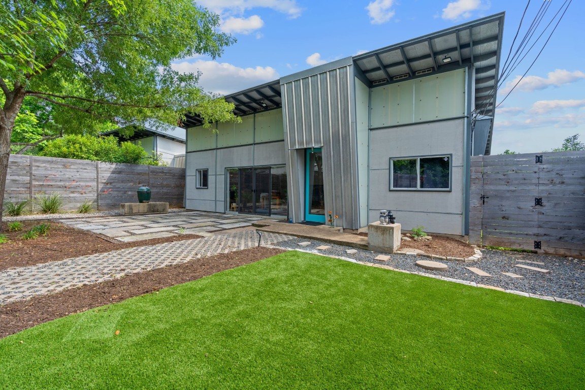 a view of a backyard with table and chairs and wooden fence