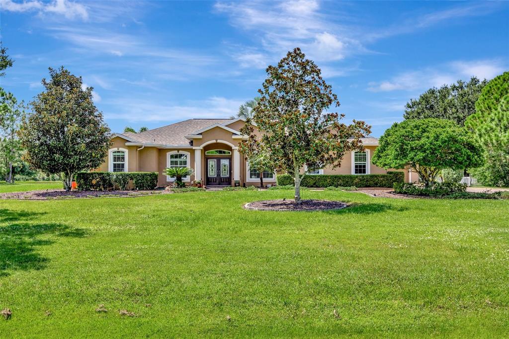 a front view of a house with a yard