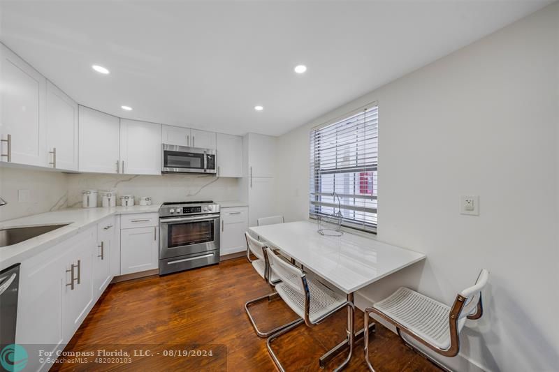 a kitchen with sink cabinets and wooden floor