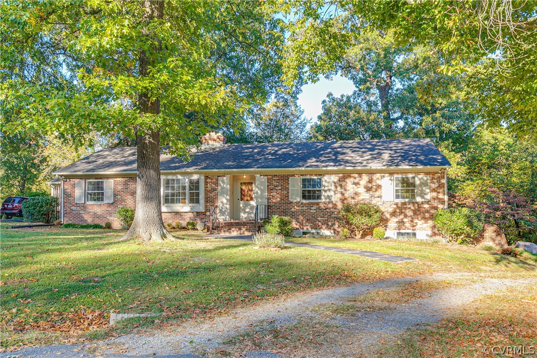 a front view of a house with yard porch and outdoor seating