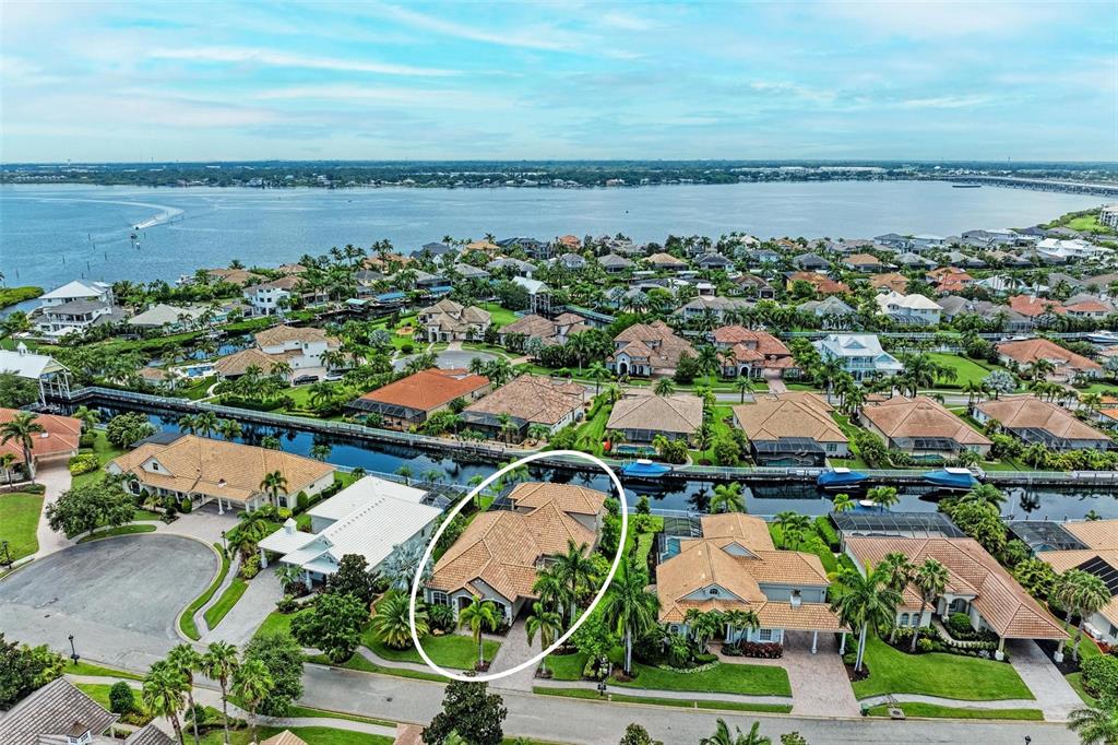 an aerial view of ocean and residential houses with outdoor space