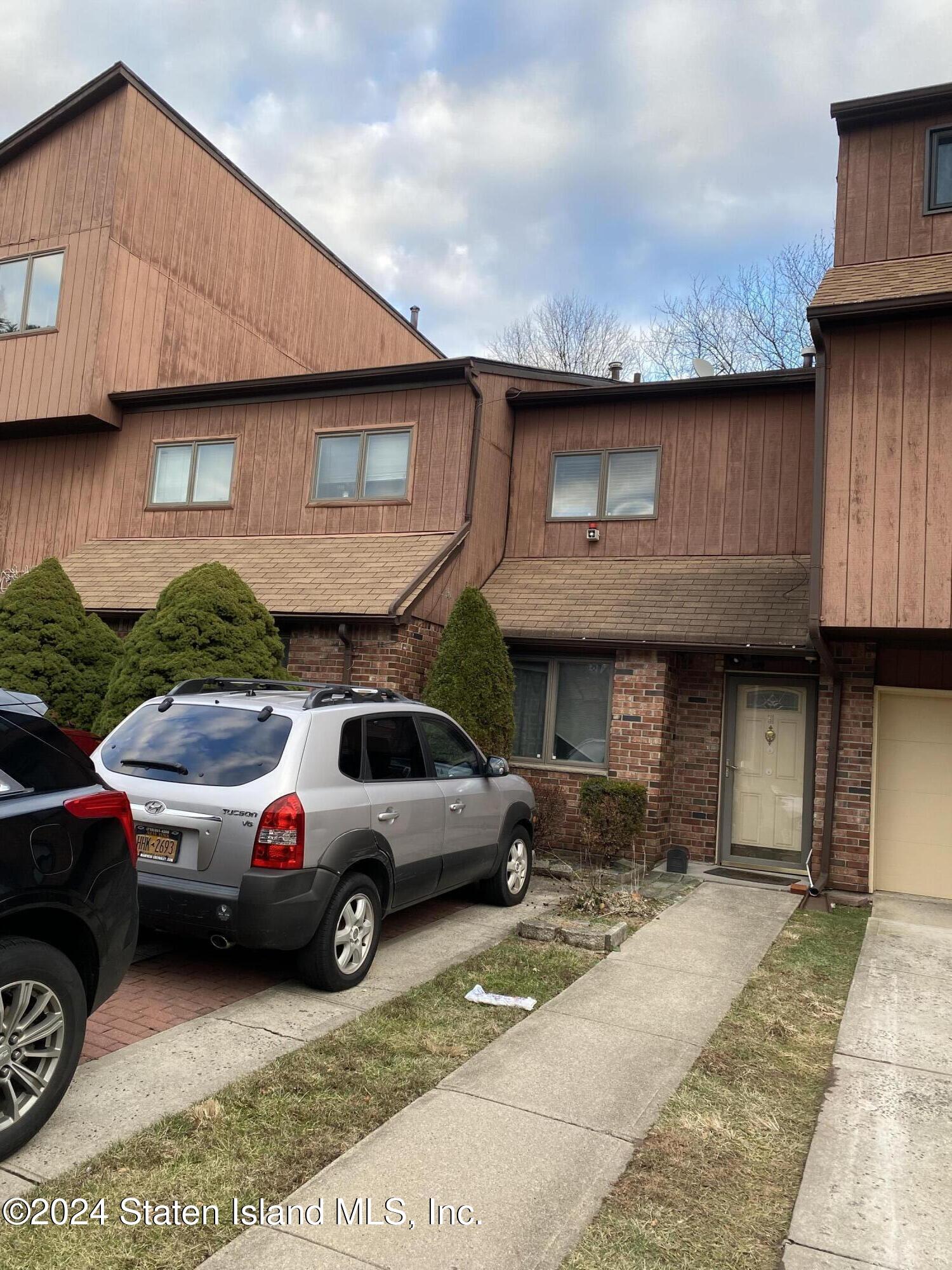 a view of a car parked in front of a house