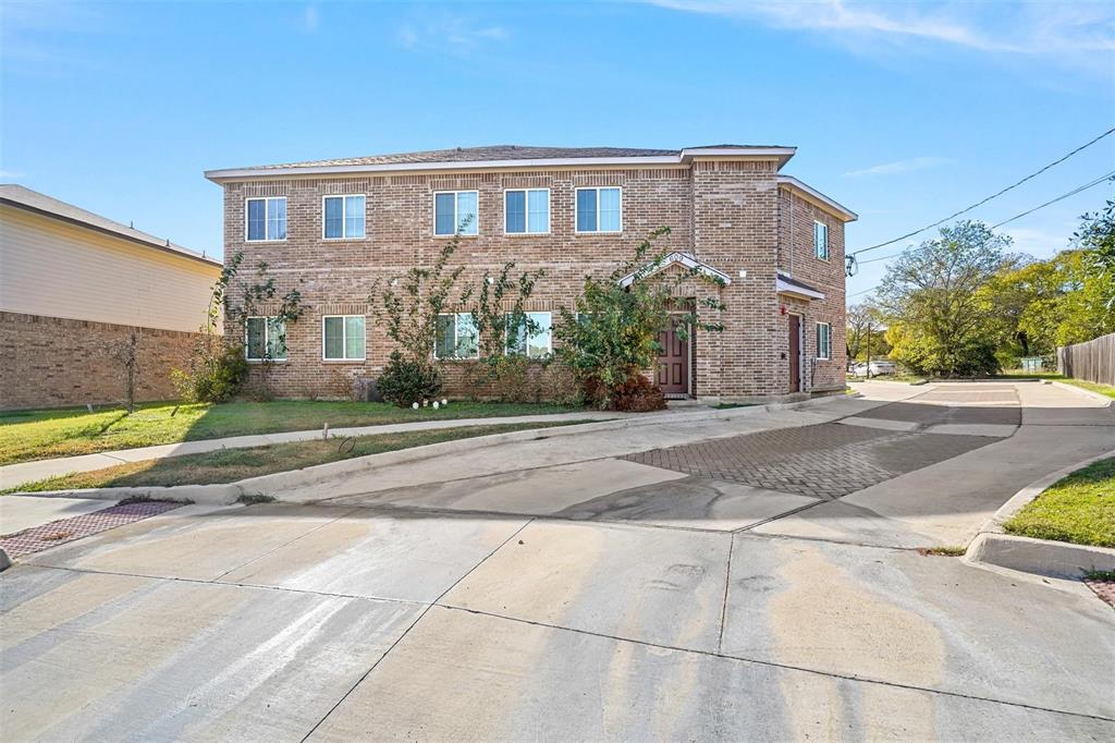 a front view of a house with a yard and a garage