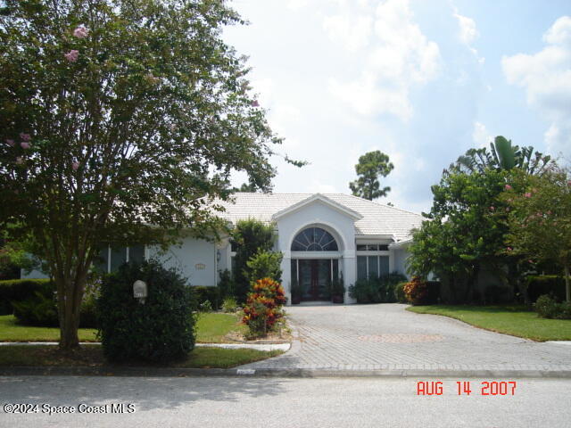 a view of a house with a yard and tree s