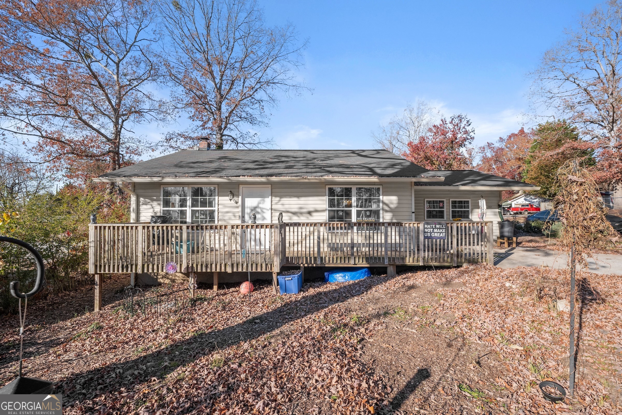 a front view of a house with a yard and lake view