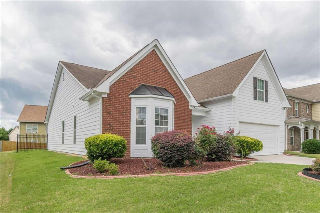 a front view of a house with a yard