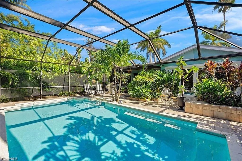 View of pool with a lanai and a patio