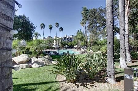 a view of a backyard with plants and a patio