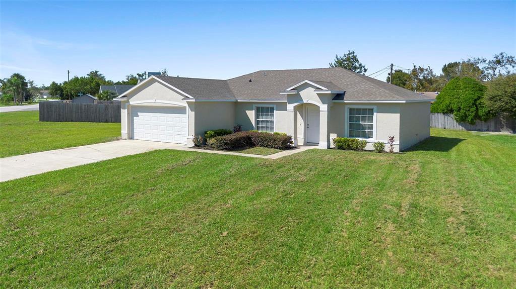 a front view of a house with yard and green space