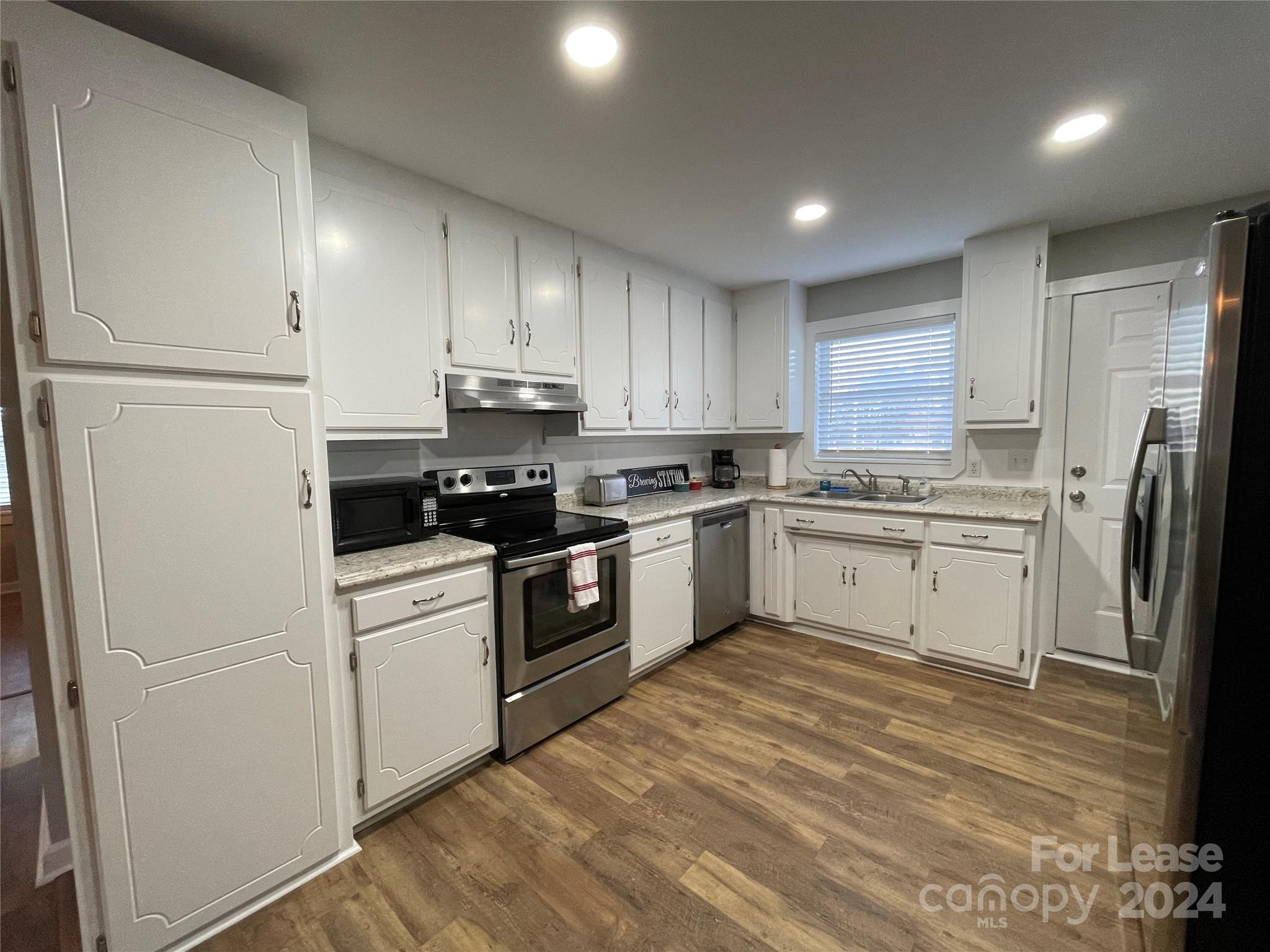 a kitchen with a white cabinets and white appliances