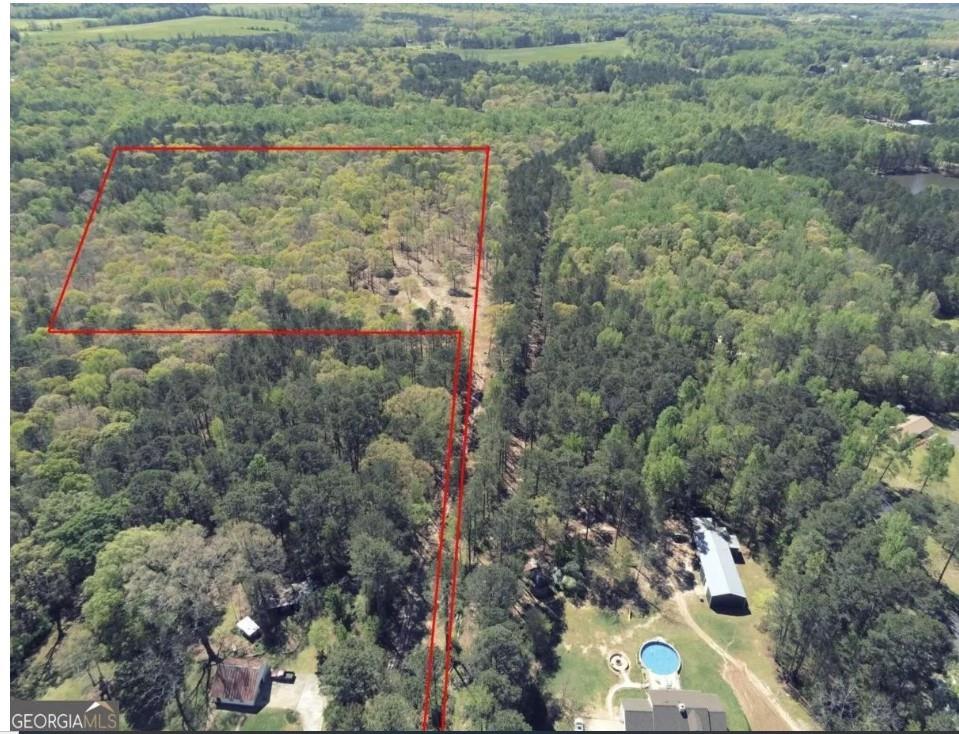 an aerial view of a houses with yard